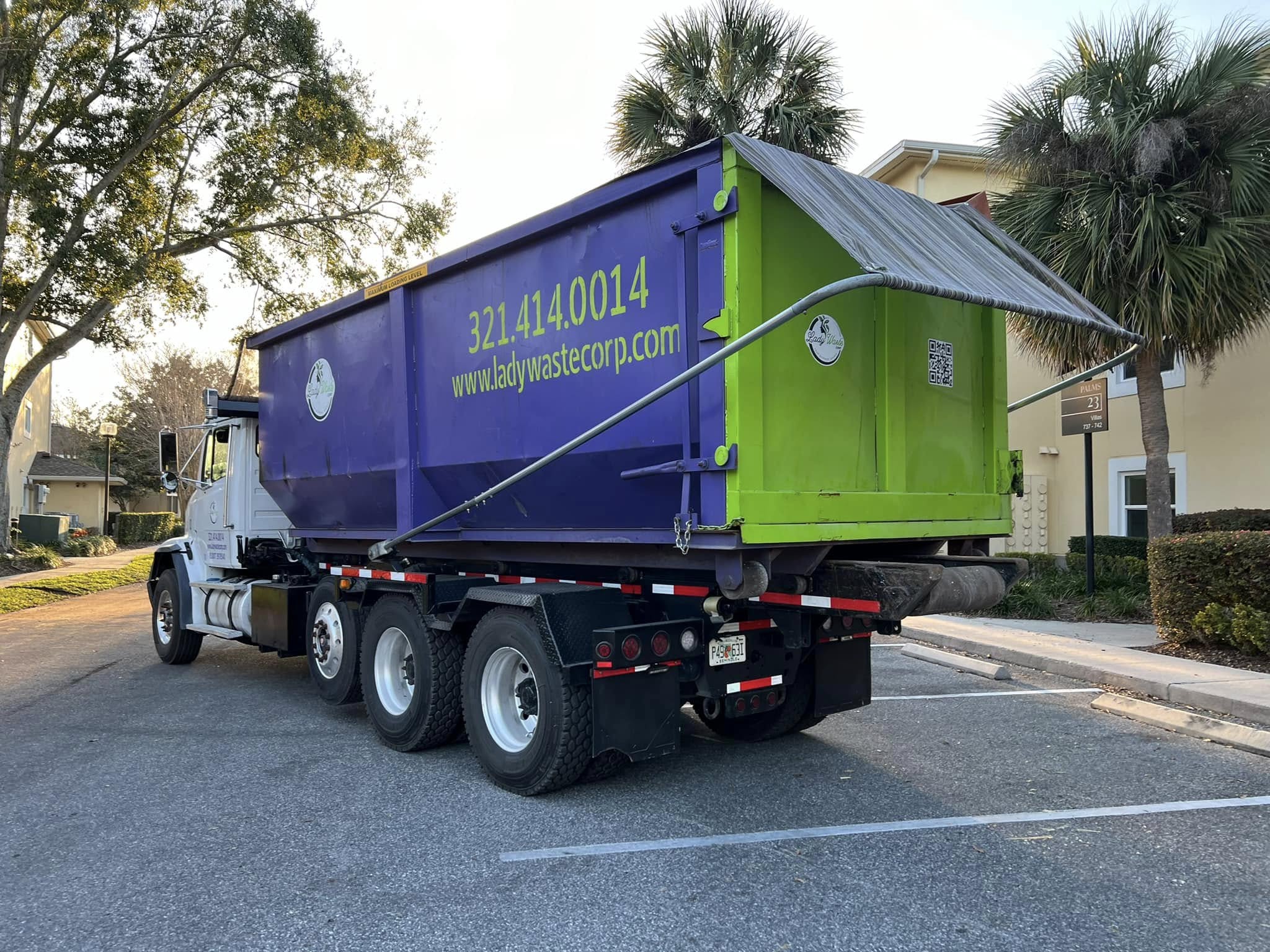 Photo of a Lady Waste truck. Lady Waste is a LEED Waste Diversion service provider and an excellent source for answers to dumpster rental faqs.